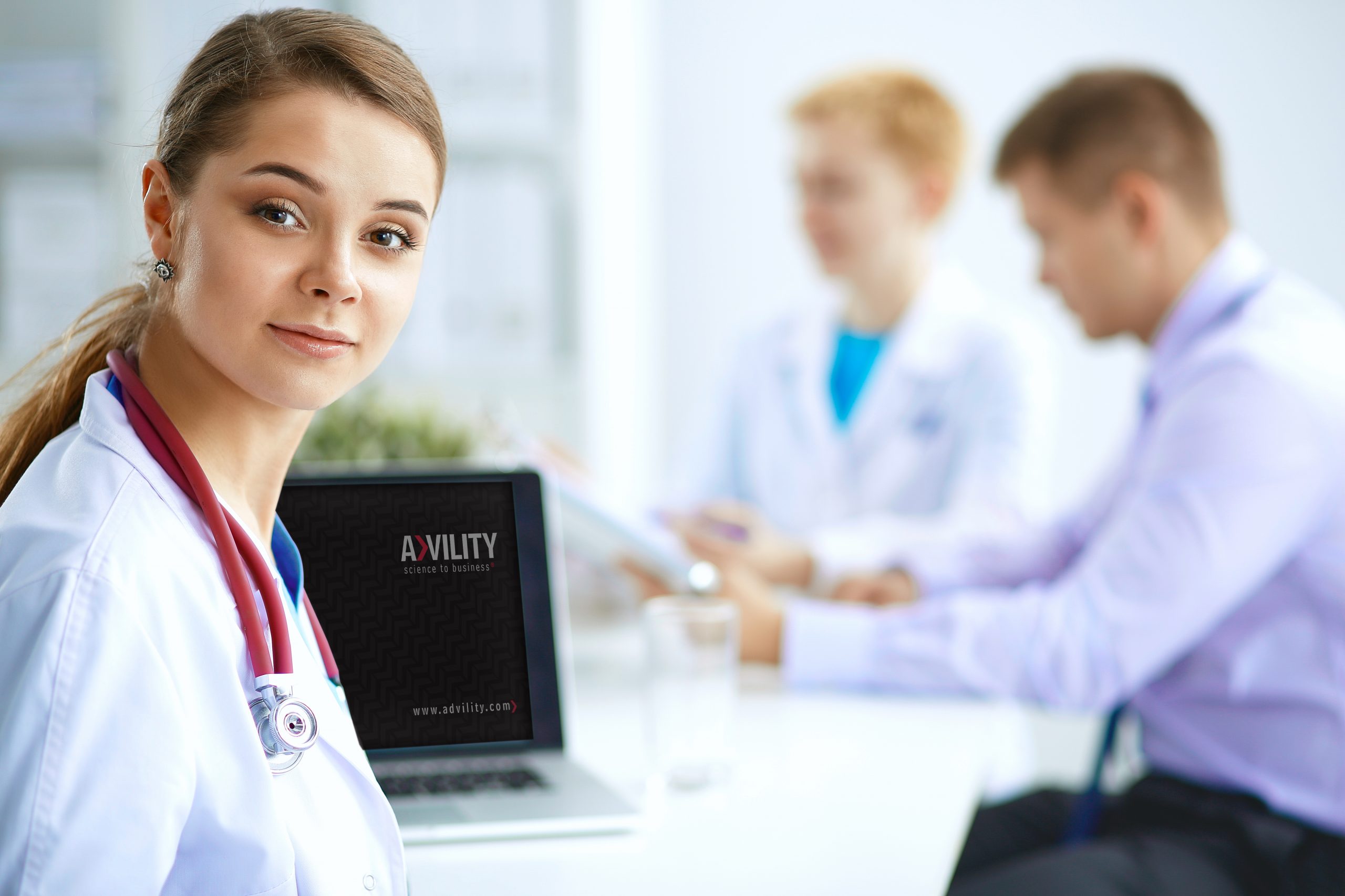 Medical team sitting at the table in modern hospital .